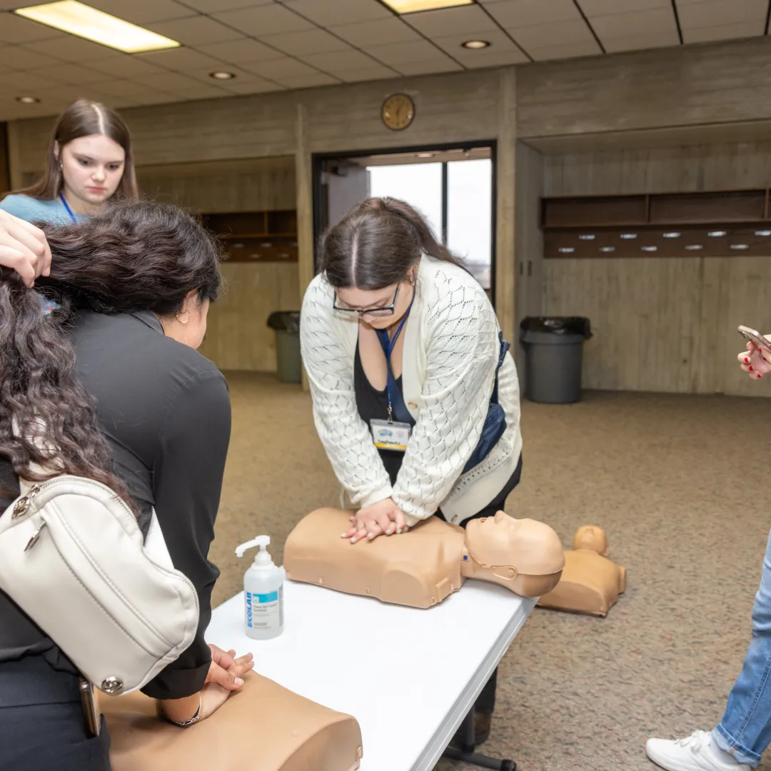 students practicing cpr on dummies
