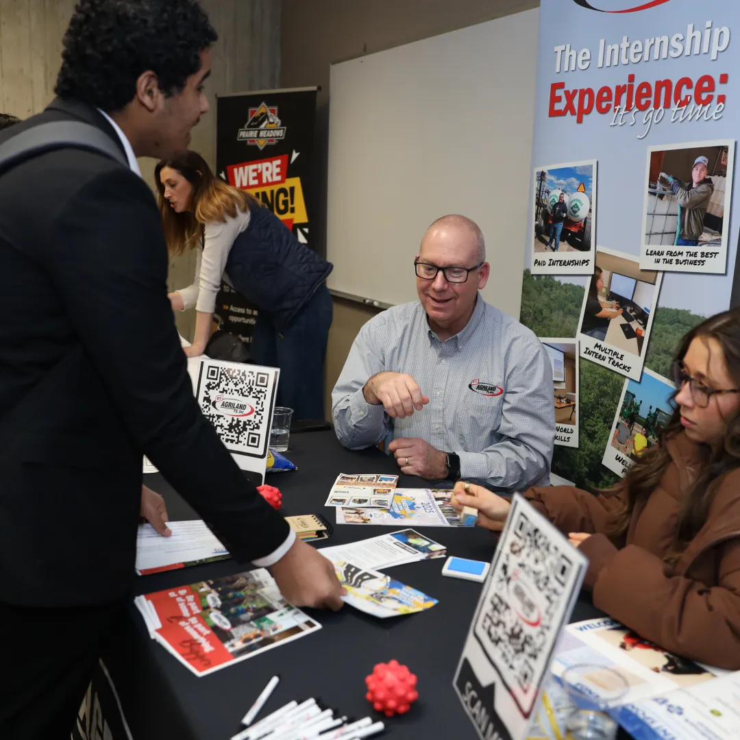 student talking to employers at career fair