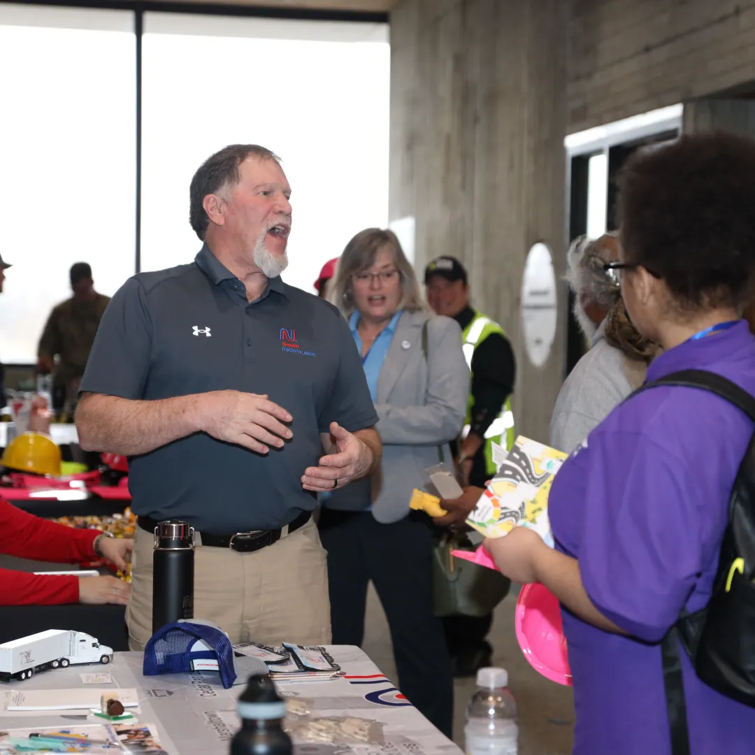 student at a career fair talking to employer